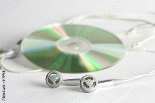 Grey and black earphones and compact disc