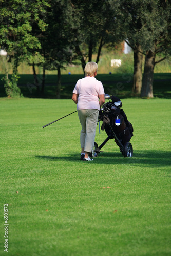 Senior woman by golf