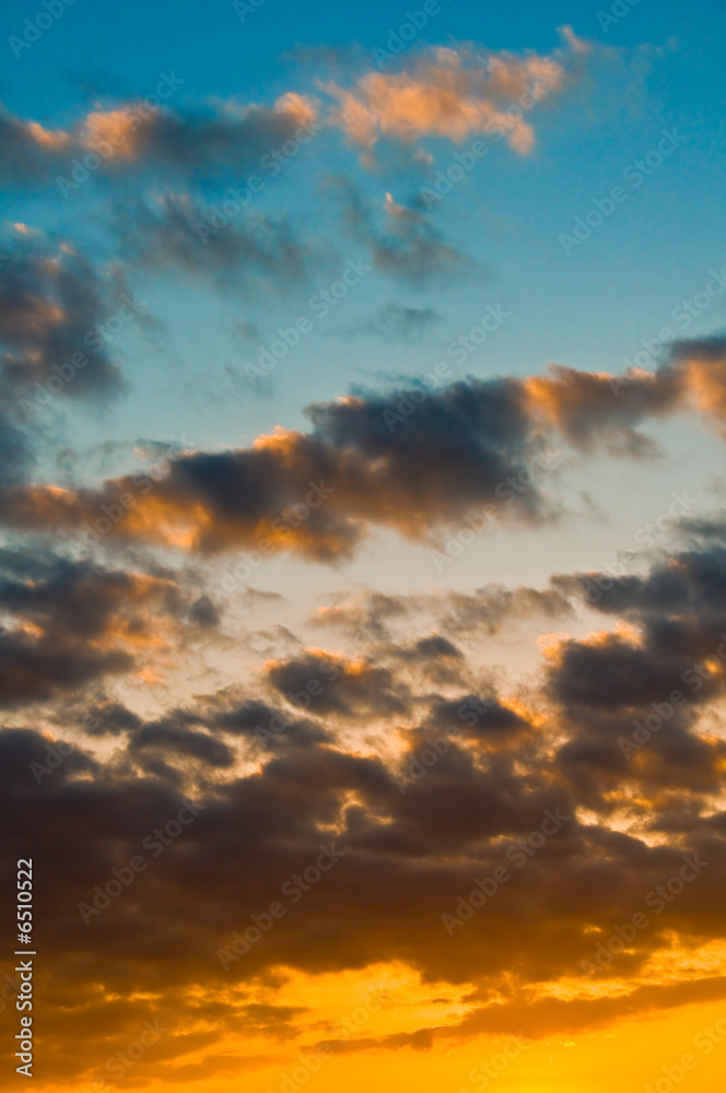 Beautiful sunset with dark blues, bright oranges, and clouds