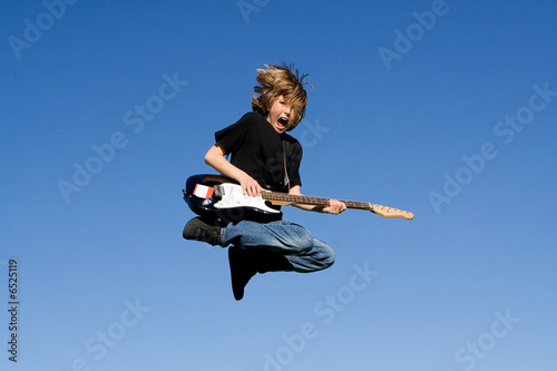 happy child playing guitar or musical instrument