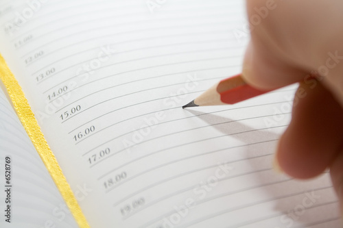 red pencil in hand over blank notes