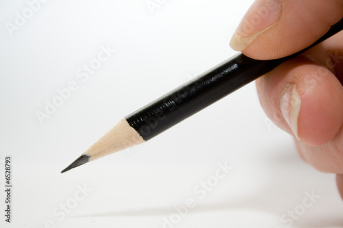 pencil in woman hand over white isolated background