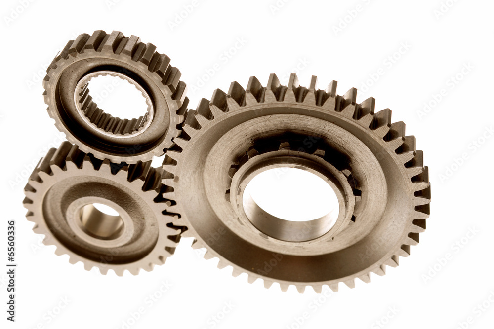 Three gears meshing together over white Three gears meshing together over white