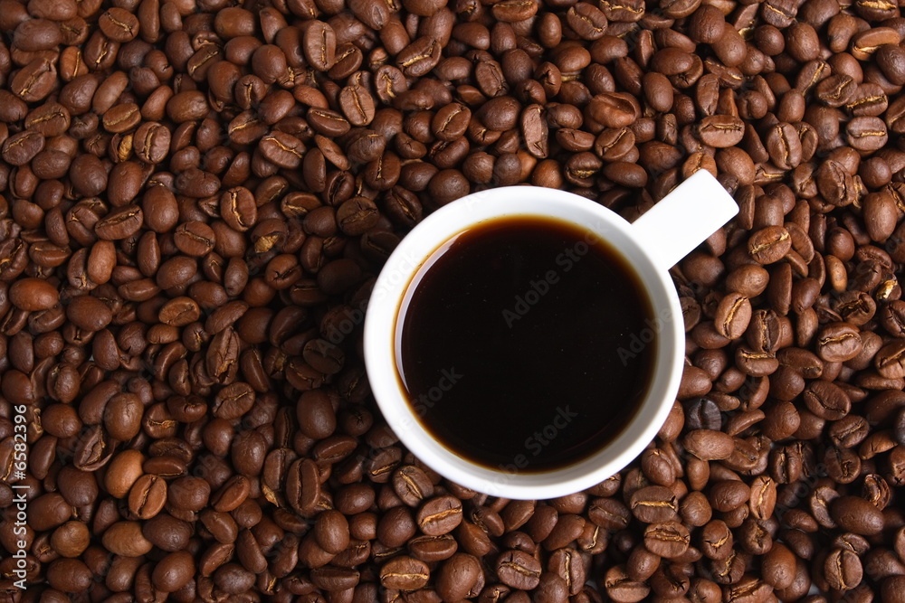 Cup with coffee, costing on coffee grain Cup with coffee, costing on coffee grain