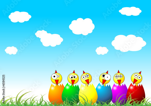Easter chicks and eggs on grass over cloudy blue sky