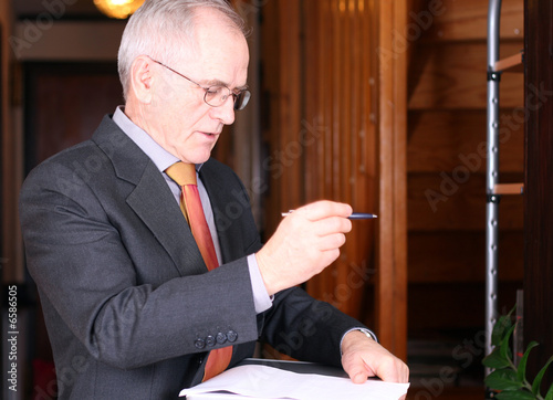 Senior real estate agent taking notes