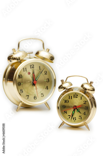 Golden alarm clocks isolated on the white