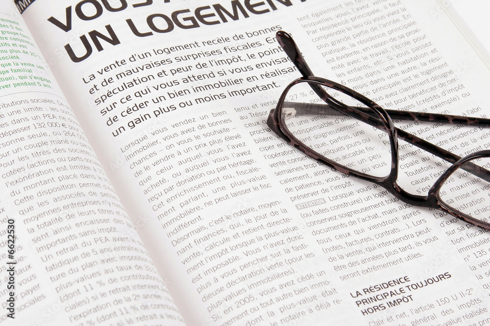 close up magazine on the table with glasses close up magazine on the table with glasses