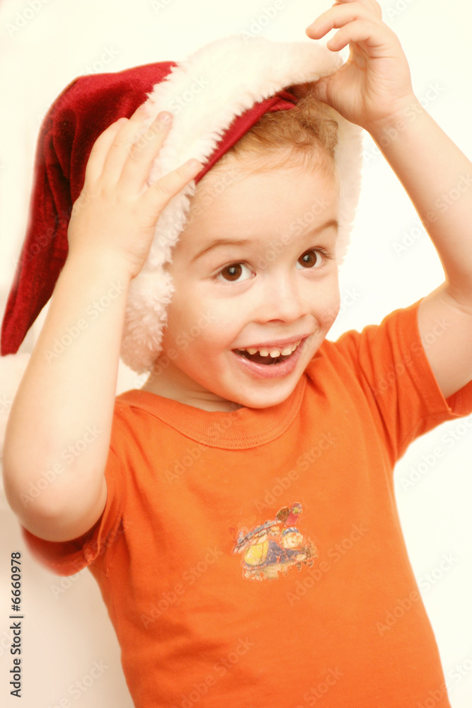 A smiling child in a New Year's cap