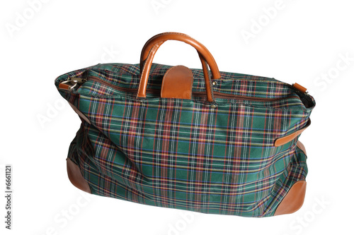 Fotografía Isolated chequered travelling bag on white background