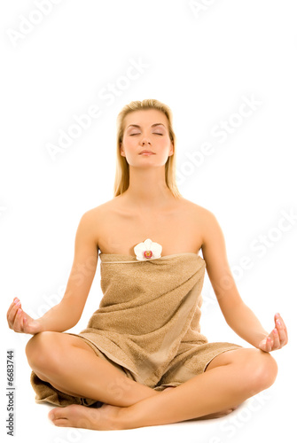 Beautiful young woman meditating isolated on white background