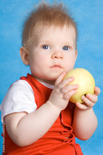 Baby boy eating an apple