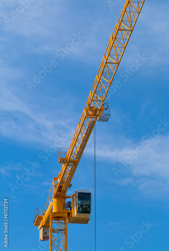Wallpaper Mural Bright yellow construction crane against clear blue sky. Torontodigital.ca