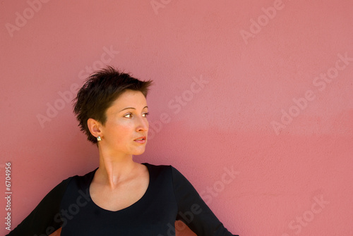 Young woman in front of the wall.