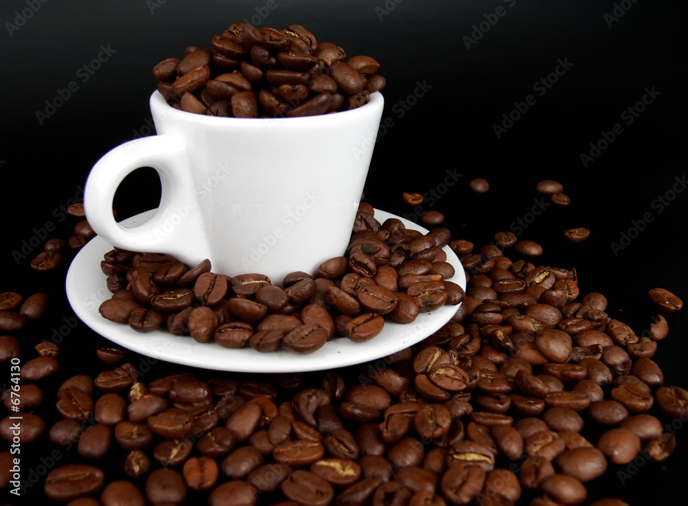 A coffee mug full of coffee beans