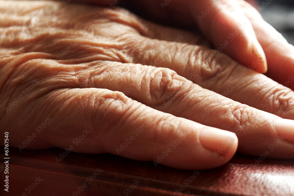 Fototapeta premium Old hands on book