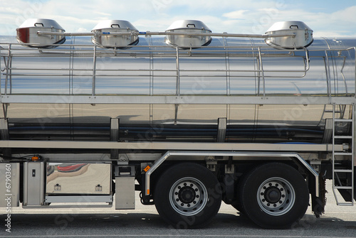 Cargo on a shiny steel semi trailer. Boggy wheels. Copy space.