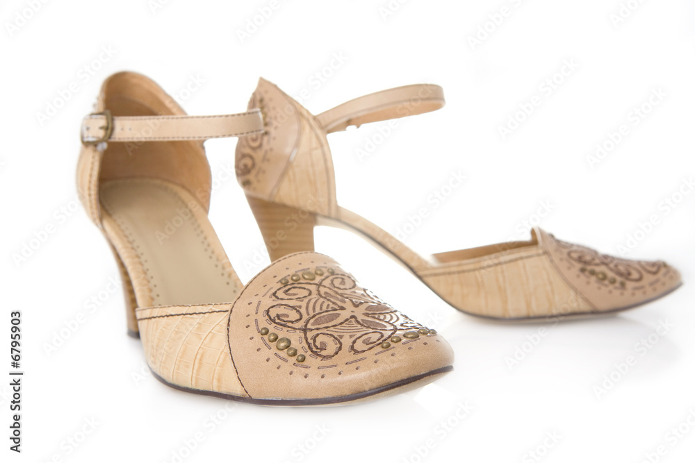 Naklejka premium Beige female shoes on a white background