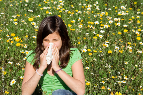 child with hayfever allergy sneezing blowing nose photo