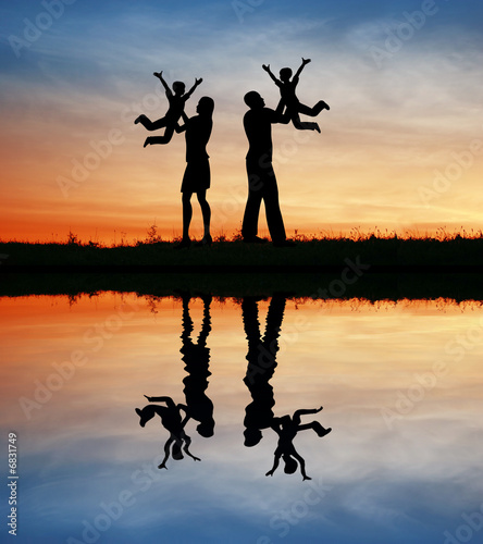 family with children on hands silhouette
