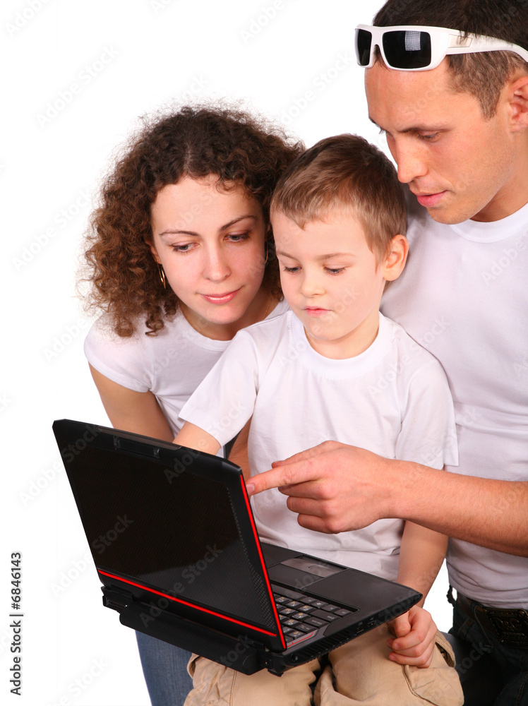 parents whit son look on notebook