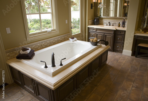 Designer bathroom with a modern tub and tile floor.