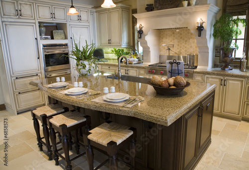Luxury home kitchen with a granite island.