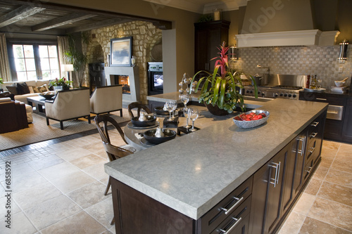 Modern kitchen with tile floor and island.