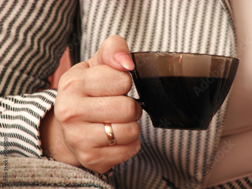 Woman's hand with cup of coffee