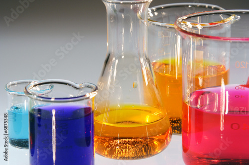 Beaker and conical flask with various colored sample