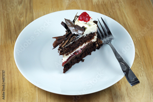 chocolate cake with cherries on a  white plate
