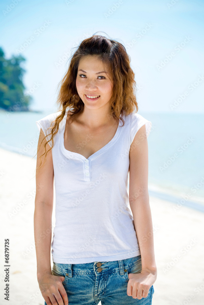 young woman smiles by the beach young woman smiles by the beach
