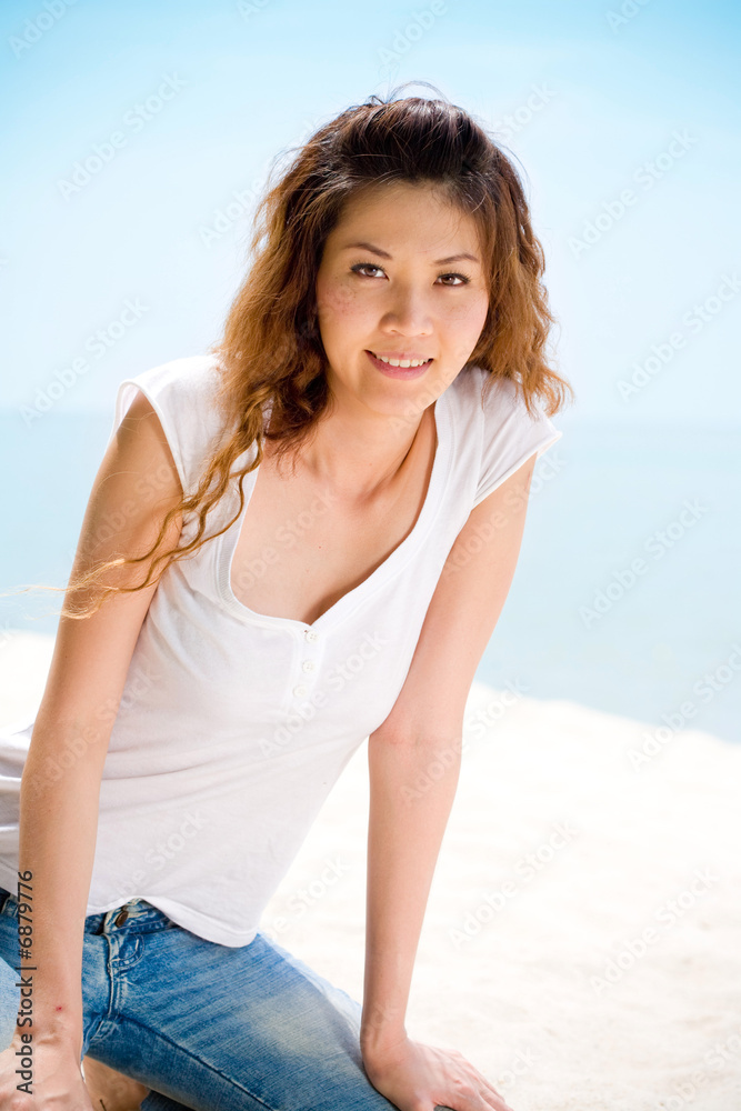 happy woman sitting at the beach happily happy woman sitting at the beach happily