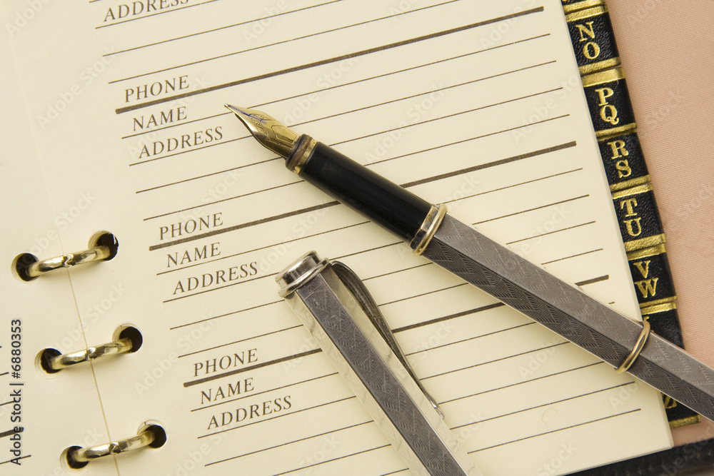 Fototapeta premium Silver fountain pen on stylish address book