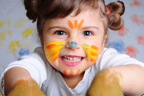 Fotografie Little girl playing with colors