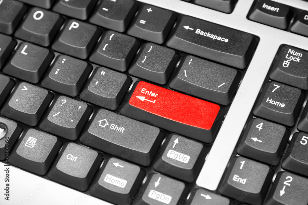 Black computer keyboard with red enter button Black computer keyboard with red enter button