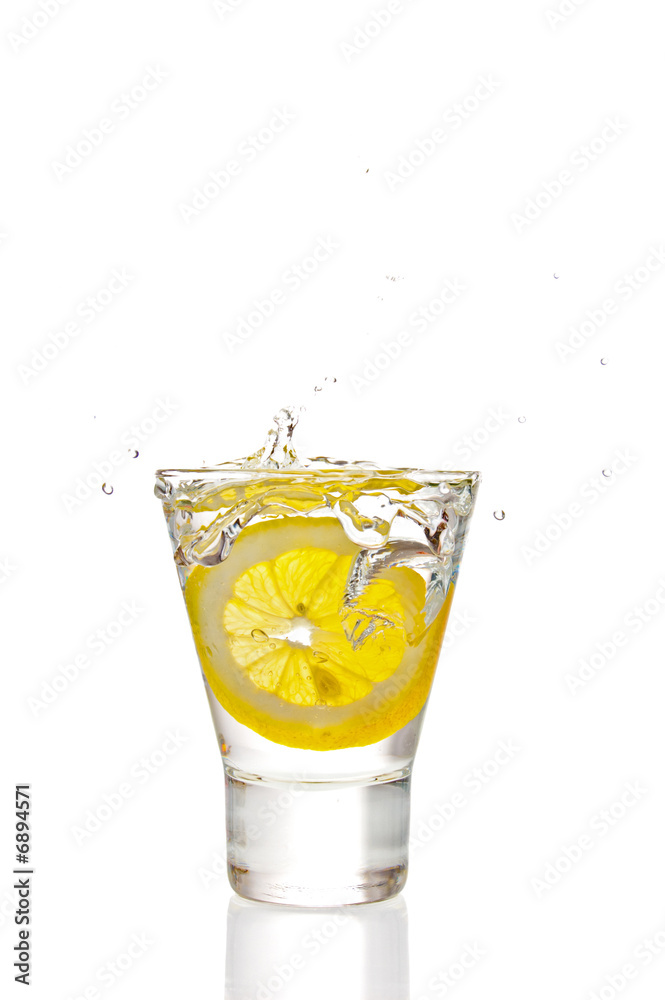 Lemon splashing into martini glass Lemon splashing into martini glass