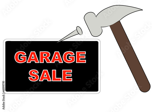 hammer and nail putting up garage sale sign