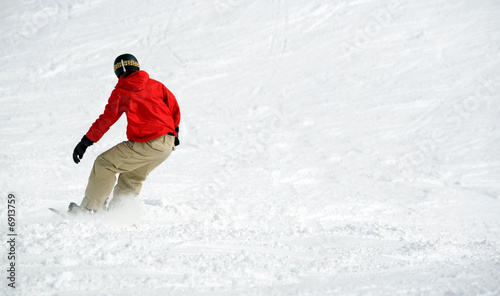 Snowboarder on snow. Lots  of space