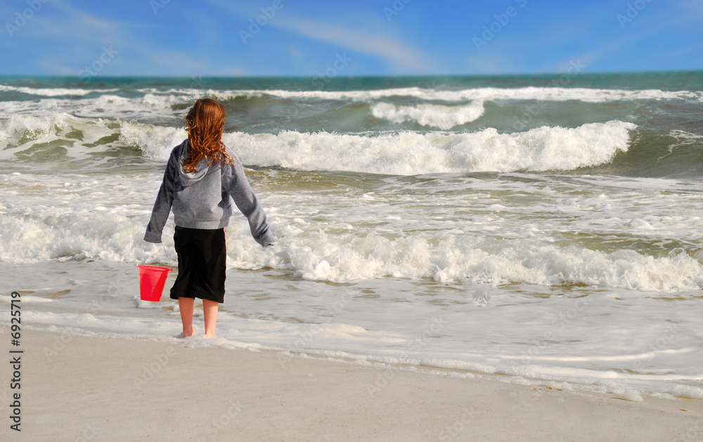 Young Girl on Beach Looking at Waves