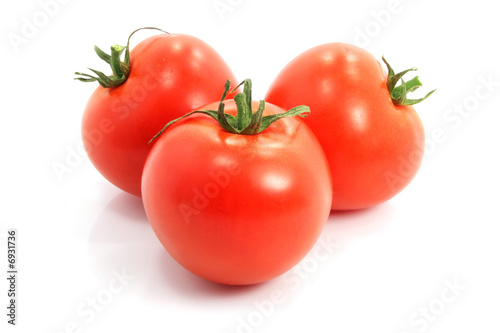 three fresh tomatoes on white background