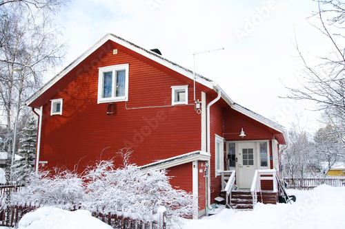 Red wooden Finnish house in winter