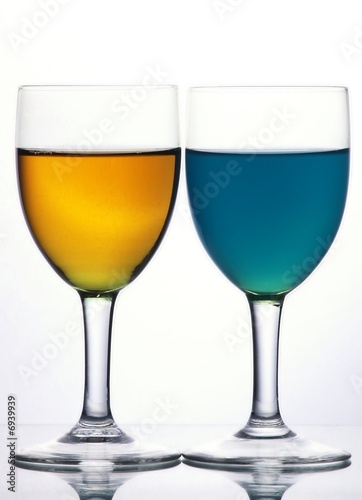 Two glasses with blue and yellow liquid