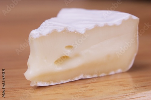 Piece of french cheese on wooden backround