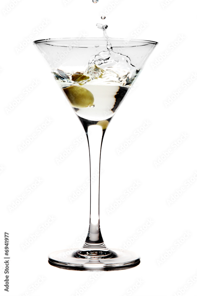 Splashing olive into a martini glass