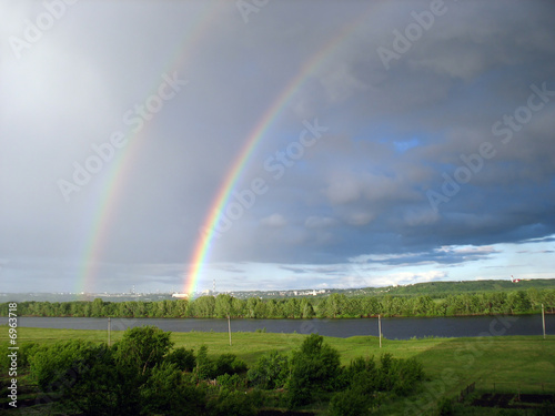 landscape with rainbow over lake