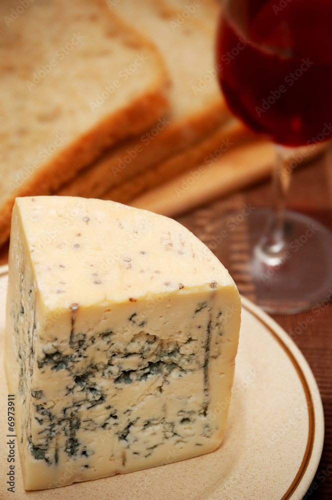 Fresh blue cheese with bread and red wine on the table