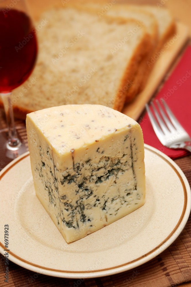Fresh blue cheese with red wine and bread on the table