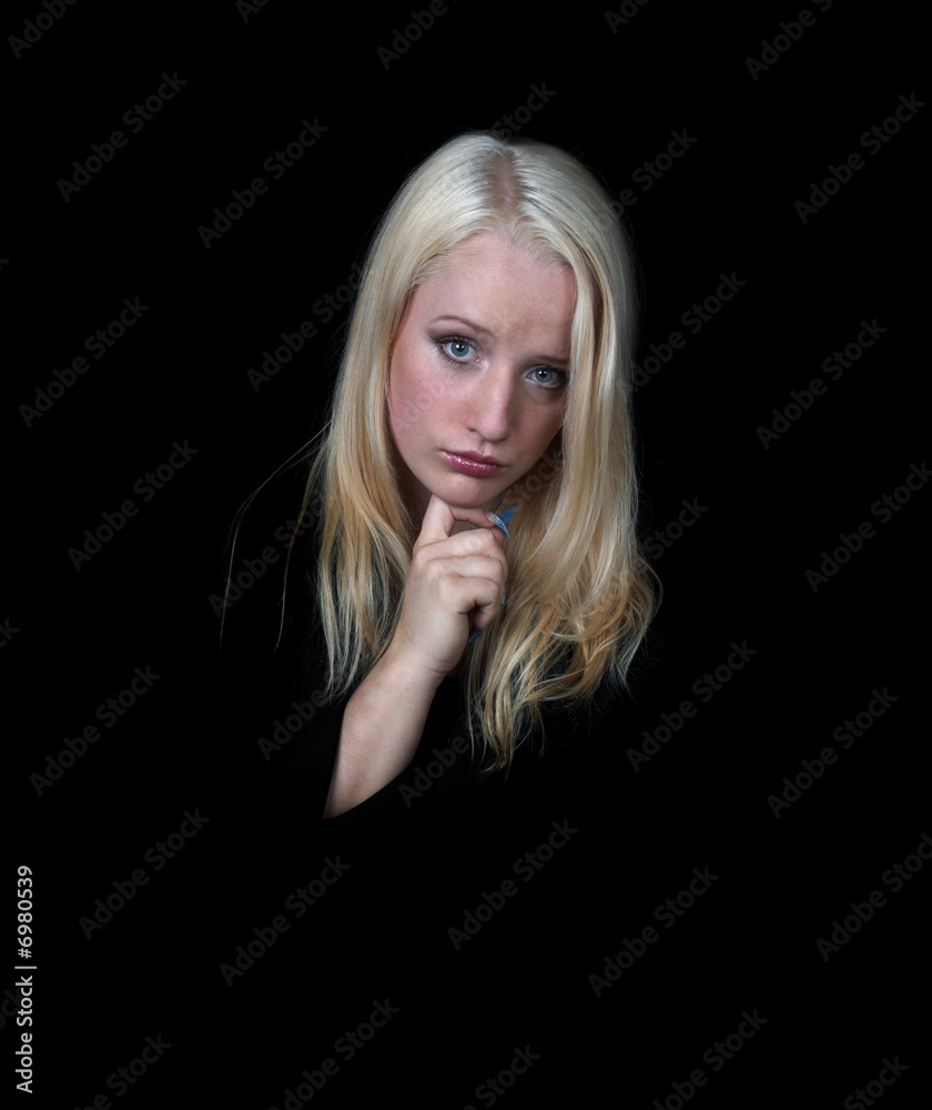 The melancholy girl on a black background. The melancholy girl on a black background.