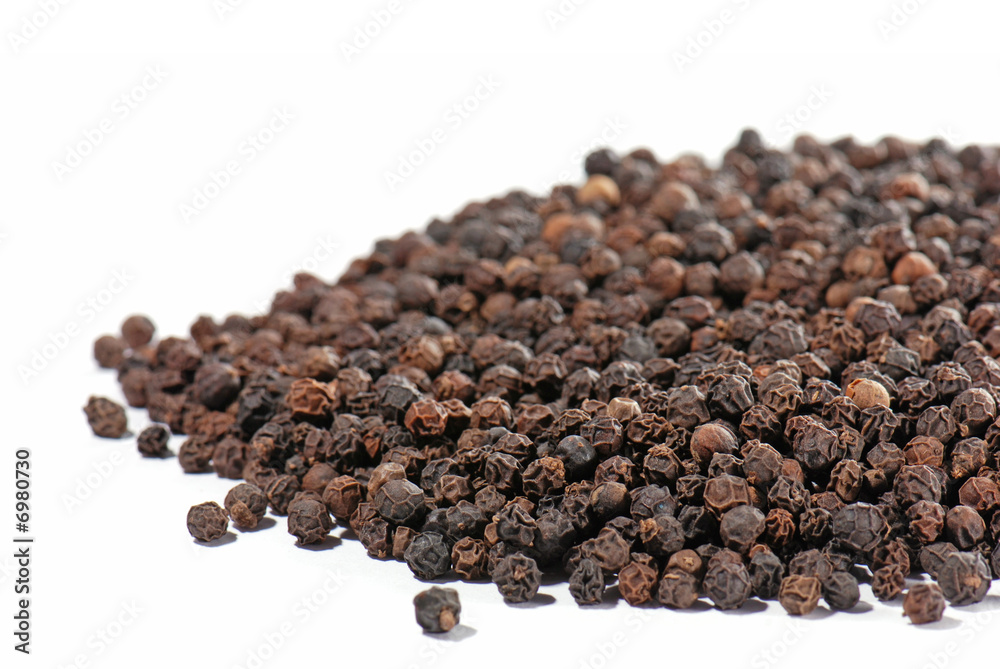 Black pepper in close-up isolated on white background Black pepper in close-up isolated on white background